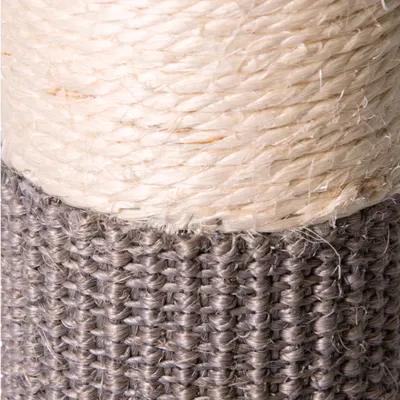 Close-up of a scratching post trunk with sisal rope and grey fabric cover.