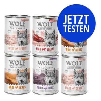 Sechs Dosen Wolf of Wilderness Nassfutter mit Sorten Great Desert, High Valley, Wide Acres und Wild Hills. Blauer Kreis mit weißer Aufschrift: JETZT TESTEN.