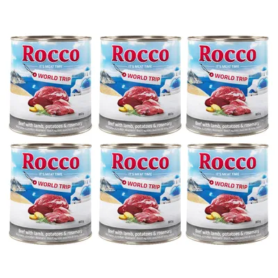 Rocco World Trip mokra hrana za pse, govedina z jagnjetino, krompirjem in rožmarinom, 800g pločevinke, paket 6. Na embalaži so prikazani kosi mesa in krajinski motivi.