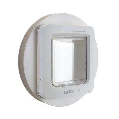 White microchip pet door with clear flap, shown mounted in a circular adapter for installation in glass or walls. Brand name 'SureFlap' visible on the front.