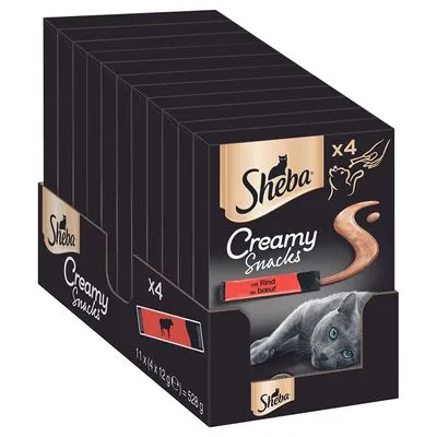 Sheba Creamy Snacks met rund, verpakking met 11 x 4 stuks à 12 g, afbeelding van kat en snack, tekst: 'mit Rind – au boeuf', merknaam Sheba duidelijk zichtbaar.
