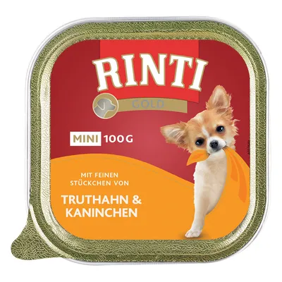 Rinti Gold Mini 100g, con trozos finos de pavo y conejo. El envase muestra un perro pequeño con un pañuelo naranja.