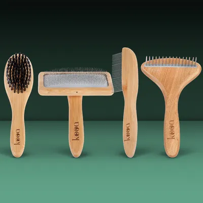 Four different wooden brushes with kooa logo: bristle brush, wire brush, comb and dematting brush. Suitable for coat care.