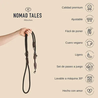 Correa negra con detalles marrones, marca Nomad Tales München. Texto visible: calidad premium, ajustable, fácil de poner, cuero vegano, ligero, set de paseo a juego, lavable a máquina 30º, hecho con amor.