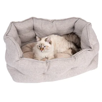 Beige pet bed with soft cushions, cat lying inside.