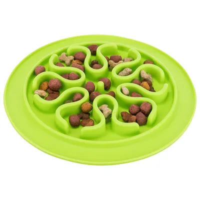 Green anti-gulp bowl with wave-shaped indentations, filled with dry food in various colours.