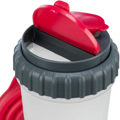 Close-up of a grey container with a red flip lid, suitable for storing pet food or snacks.