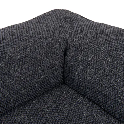 Close-up of a dark grey, textured fabric cover with visible seams.