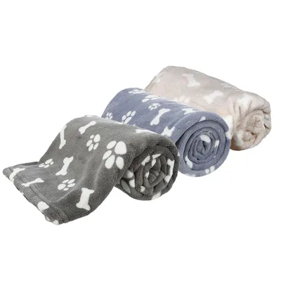 Three rolled-up blankets in grey, blue and beige with white paw and bone patterns.