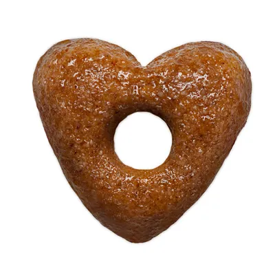 Crocchetta a forma di cuore con foro centrale, superficie marrone e consistenza compatta visibile. Nessun marchio o testo presente.