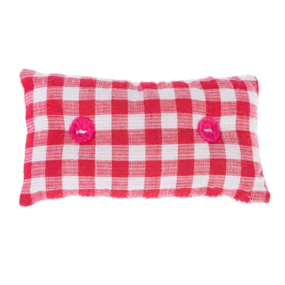 Punavalkoruudullinen tyyny, kaksi pinkkiä nappia, suorakulmainen muoto.