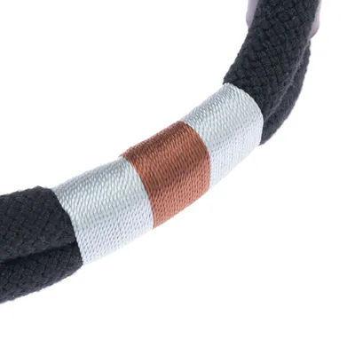 Close-up of a black rope with silver and copper-coloured band, suitable for pet accessories or toys.