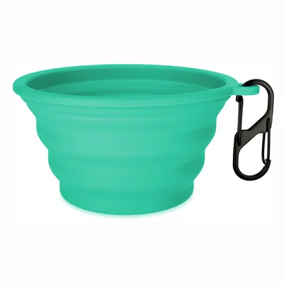 Foldable green silicone bowl with black carabiner, ideal for travel.