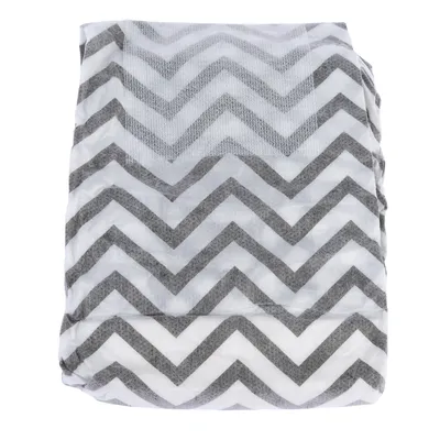 Grey and white chevron pattern on a folded fabric surface.