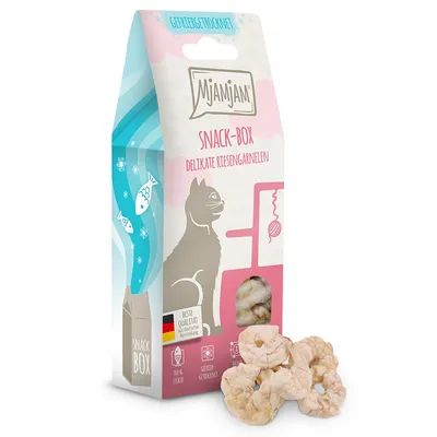 Boîte de snacks MjAMjAM pour chats, texte visible : SNACK-BOX DELIKATE RIESENGARNELEN, 100 % lecker, gefriergetrocknet, fenêtre montrant des crevettes séchées, mention Beste Qualität.