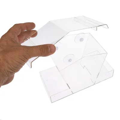 Hand holding transparent acrylic container with suction cups, suitable for mounting or attachment.