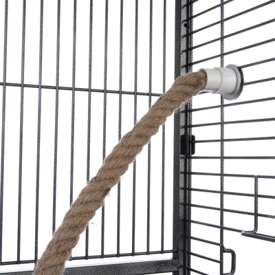 Rope made from natural material, attached to a metal cage with plastic holder.