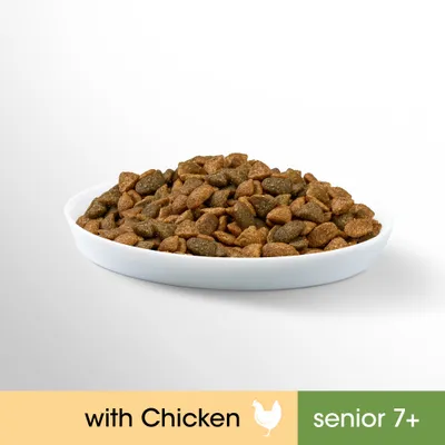 Bowl of dry pet food. Visible text: with Chicken, senior 7+