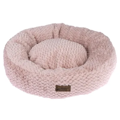 Panier rond en tissu tricoté rose avec étiquette Modern Living visible sur le devant.