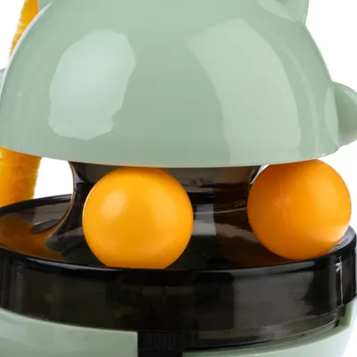 Toy with green casing and two yellow balls, suitable for interactive play.