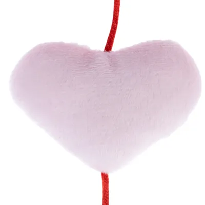 Soft pink heart-shaped plush toy with a red string attached at the top and bottom, fabric texture visible.
