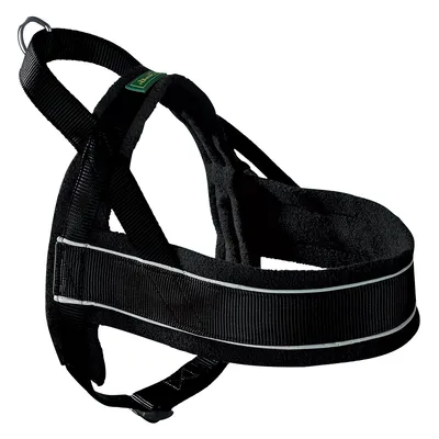 Black dog harness with reflective strip, metal ring for lead attachment, and green label on strap. Made from fabric and webbing materials. No visible brand or size information.