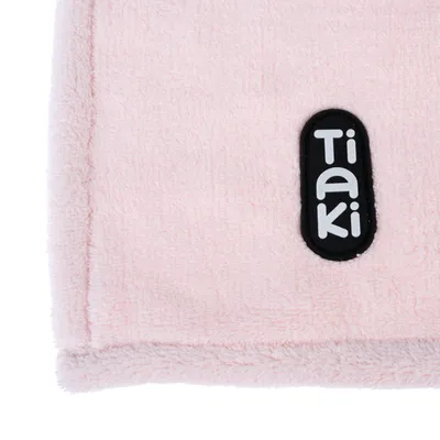 Tiaki logo on pink fabric material.