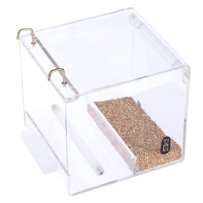 Transparent acrylic feeder with metal hook and compartment for seed feed. Visible inner rod for attachment.