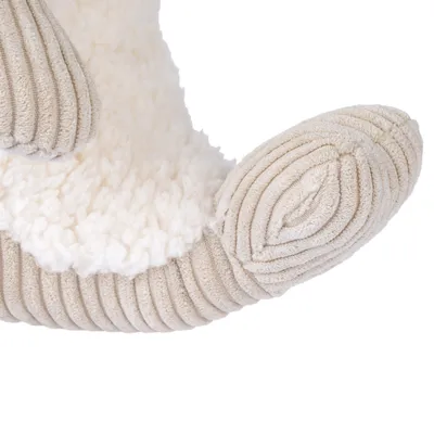 Close-up of a toy made of soft plush and ribbed fabric in beige.
