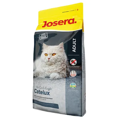 Josera Catelux Adult kattefoder med billede af langhåret kat. Synlig tekst: Ekstrem Anti-Haarballen, Malt & Fjer, Urin-pH 6,0–6,5. Produktnavn og mærke tydeligt vist.