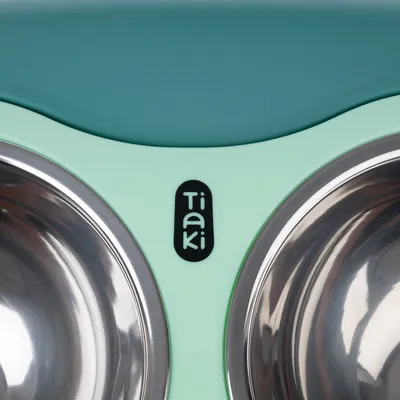 Tiaki double bowl made of stainless steel with mint green and turquoise plastic frame.