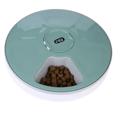 Round green feeder with an open compartment containing brown dry food.