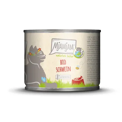Mjamjam Bio wieprzowina, naturalnie smaczna, bez zbóż. Ilustracja kota z wiankiem kwiatowym i miską na zielonej trawie.