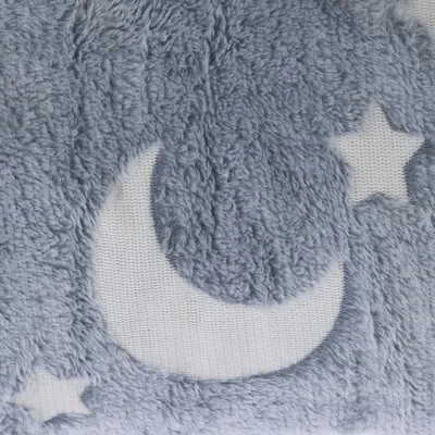 Graues, flauschiges Material mit Mond- und Sternmotiv auf weissem Hintergrund.