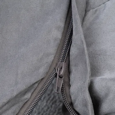 Close-up of a grey zip on a fabric cover, showing the material's detailed workmanship.