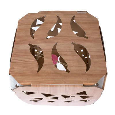 Cardboard box with wood look and cut-out leaf motifs, partially visible toys inside.