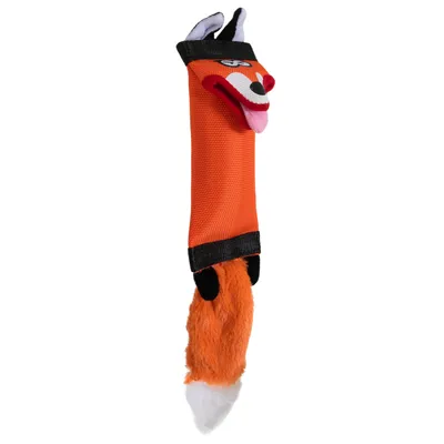 Jouet pour chien en forme de renard, corps en tissu orange avec tête souriante, oreilles noires et queue en peluche orange et blanche, pattes noires visibles.