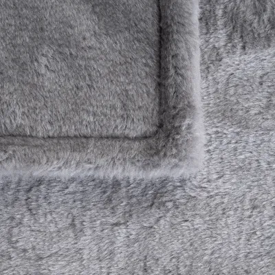 Close-up of grey, soft plush material with visible seams. Suitable for pet beds or blankets.