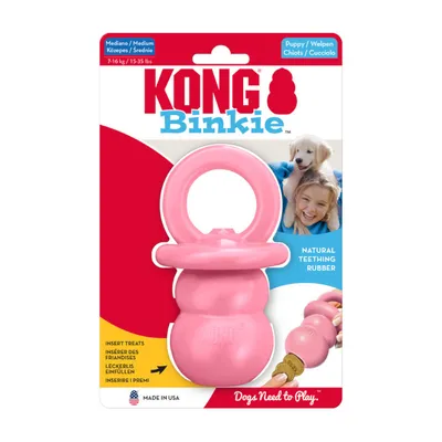KONG Binkie, jouet rose pour chiot, caoutchouc naturel, taille medium 7–16 kg, insert treats, fabriqué aux USA, texte : Dogs Need to Play.