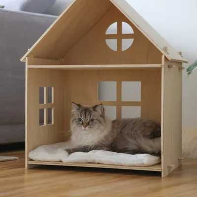 Wooden house with window design, suitable as pet accommodation. Equipped with a white cushion inside.