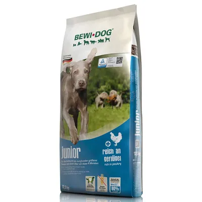 BEWI DOG junior dry dog food 12.5 kg bag, rich in poultry, blue and white packaging with image of a dog and text in German and English visible on front.