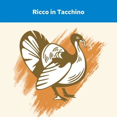 Testo: Ricco in Tacchino, con illustrazione stilizzata di un tacchino su sfondo arancione. Il testo indica la presenza di tacchino come ingrediente principale.