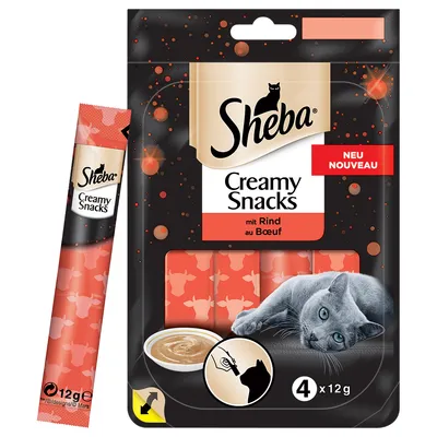 Sheba Creamy Snacks mit Rind au Boeuf -pakkauksessa 4 x 12 g annospussia, kuvassa harmaa kissa ja kulhollinen tahnamaista herkkua. Pakkauksessa teksti 'NEU NOUVEAU'.
