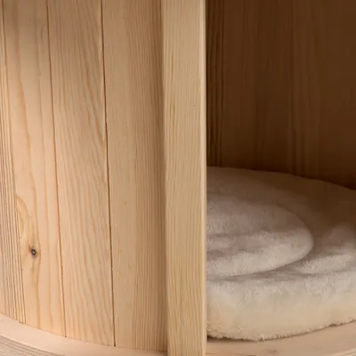 Wooden structure with a soft, round cushion inside. Close-up of a piece of furniture or pet furniture.