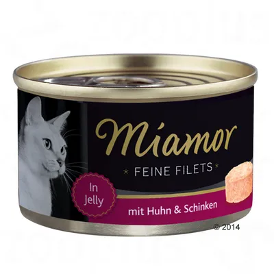Miamor Feine Filets In Jelly mit Huhn & Schinken, lattina con immagine di un gatto bianco e pezzo di filetto visibile sull'etichetta. Testo in tedesco.