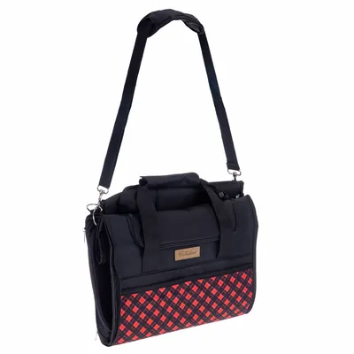 Sac de transport noir avec bandoulière réglable, poignée et poche avant à motif rouge et noir. Étiquette visible : 'Comfort'. Matière textile.
