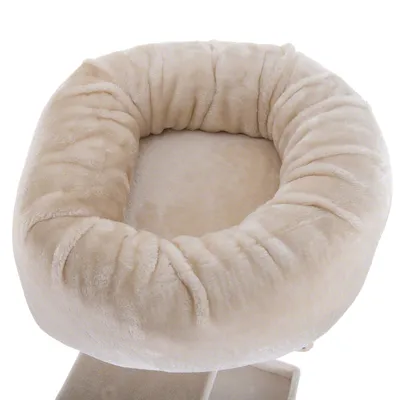 Cama redonda beige para mascotas con borde elevado y superficie de felpa suave, vista superior. Material textil visible.