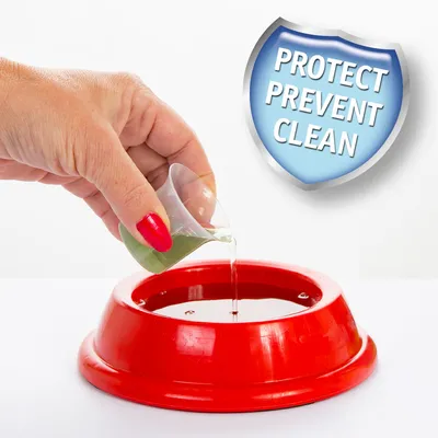 Hand pouring liquid from a small cup into a red bowl, with a shield icon showing the words 'Protect Prevent Clean'.