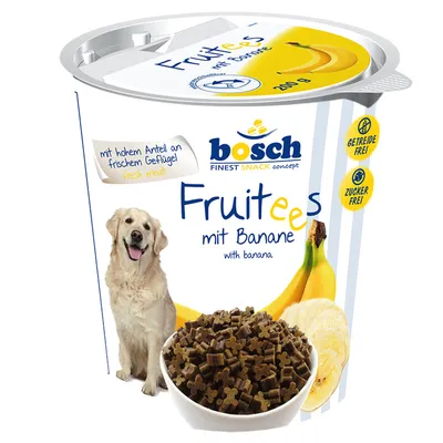 bosch Fruitees mit Banane, 200 g, met afbeelding van hond, stukjes snack in kom, tekst: getreidefrei, zuckerfrei, mit hohem Anteil an frischem Geflügel. Bananen zichtbaar op verpakking.