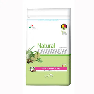 Sac de croquettes Natural Trainer Junior Maxi (9–24), maxi breeds >30 kg, made in Italy, images de pommes et herbes, texte en anglais et italien visible sur l’emballage.